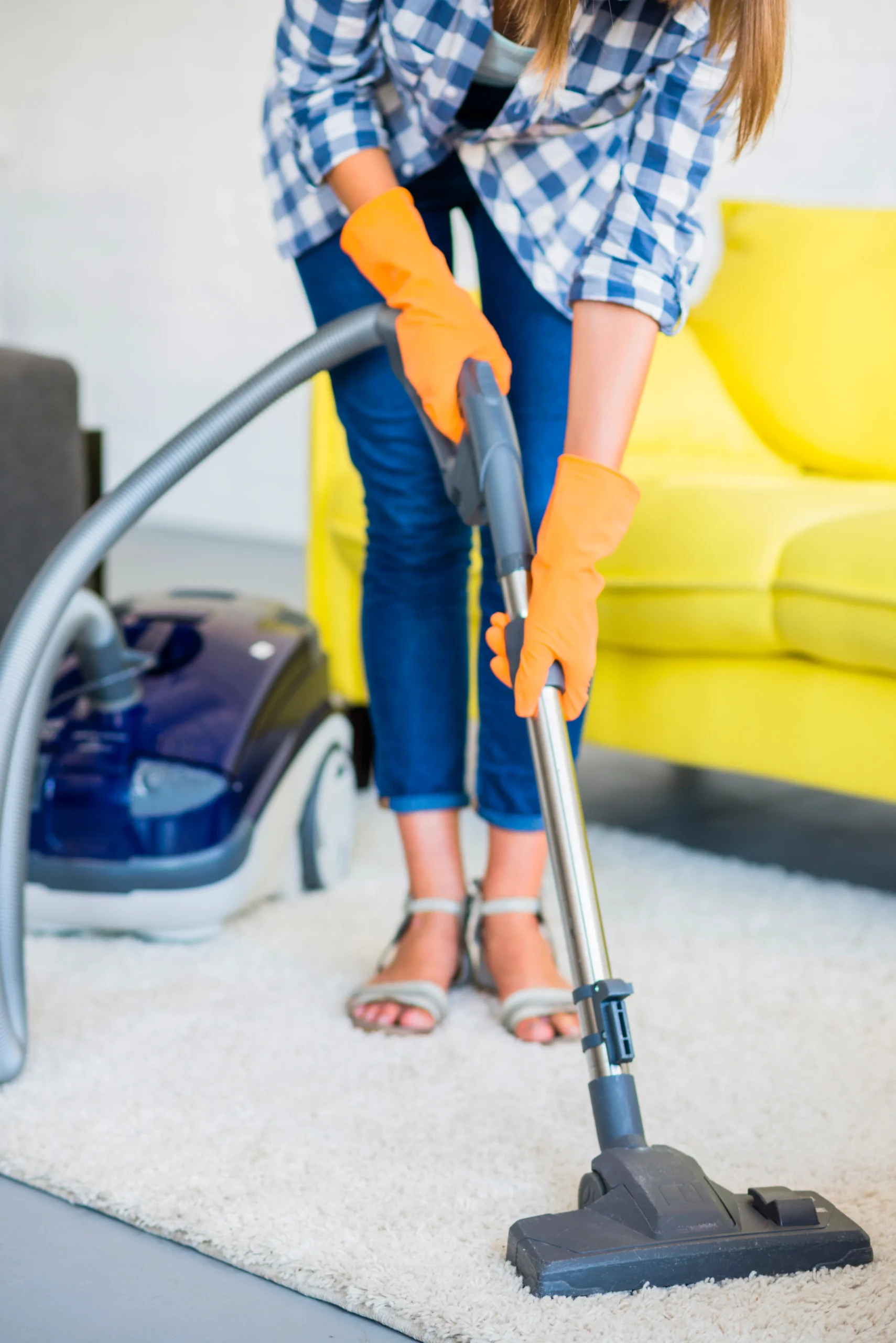 close-up-woman-s-hand-cleaning-carpet-with-vacuum-cleaner